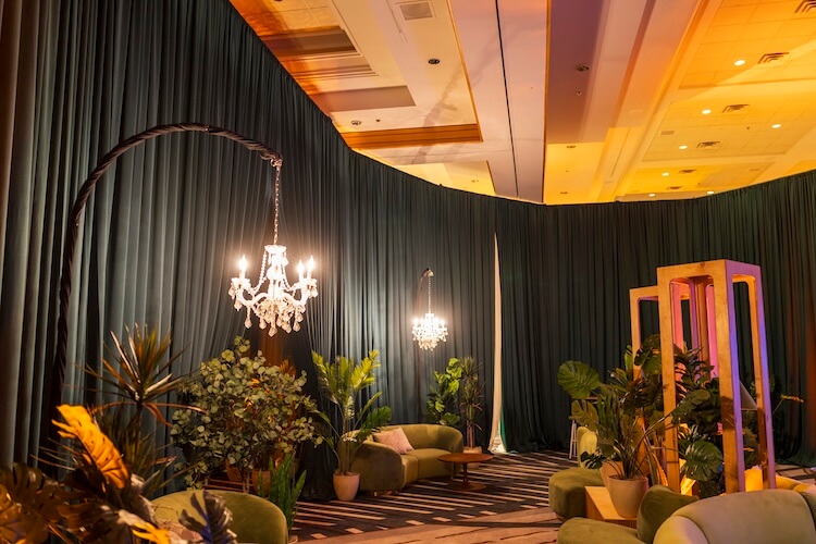 Green pipe and drape lounge event setup
